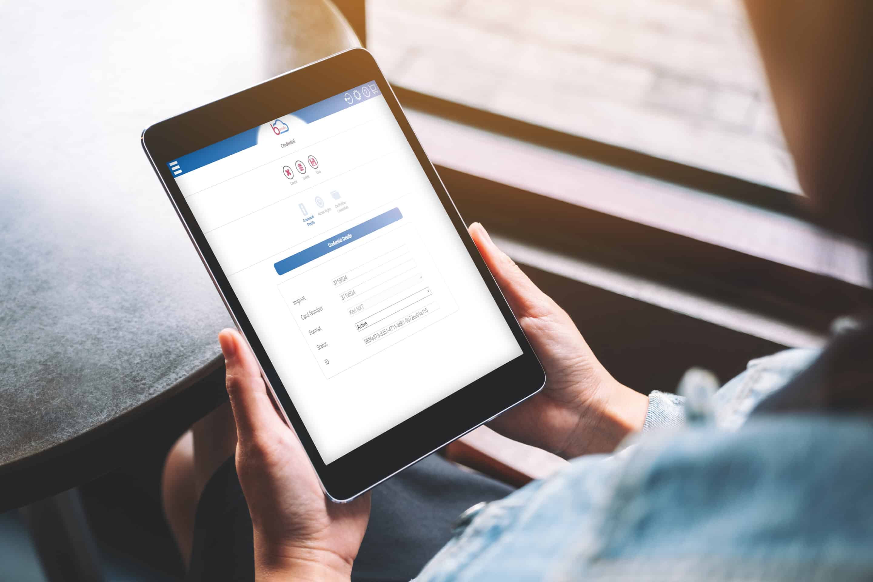 Mockup image of a woman holding black tablet with white blank sc TabletBorealis scaled